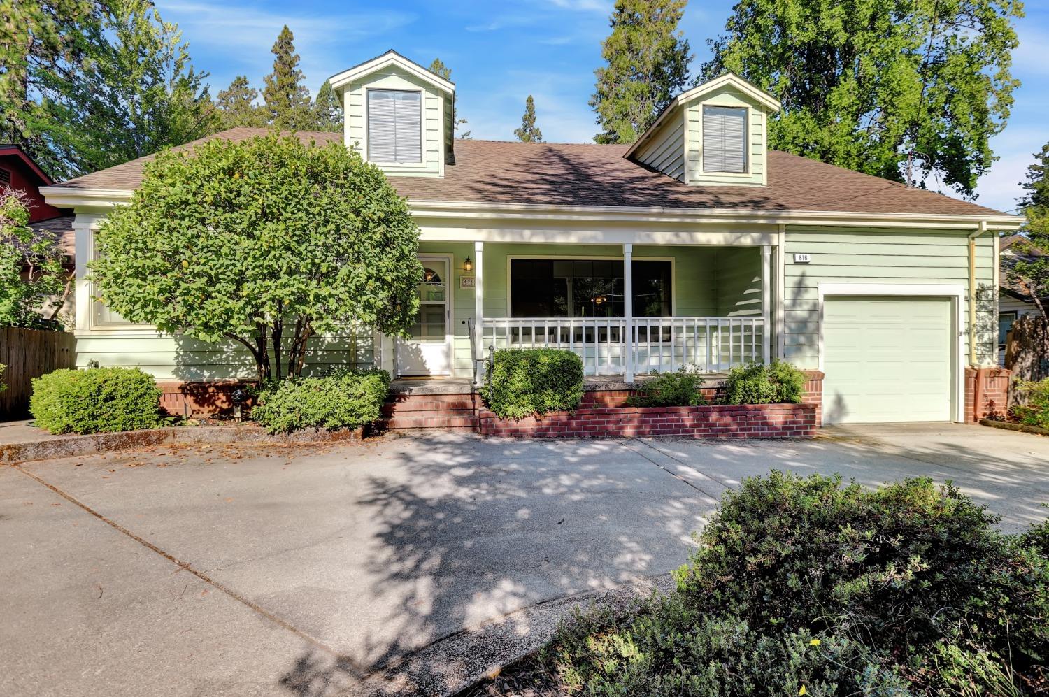 a view of a house with a small yard and plants