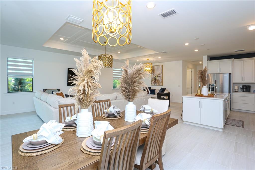 a kitchen with stainless steel appliances kitchen island granite countertop a table and chairs in it