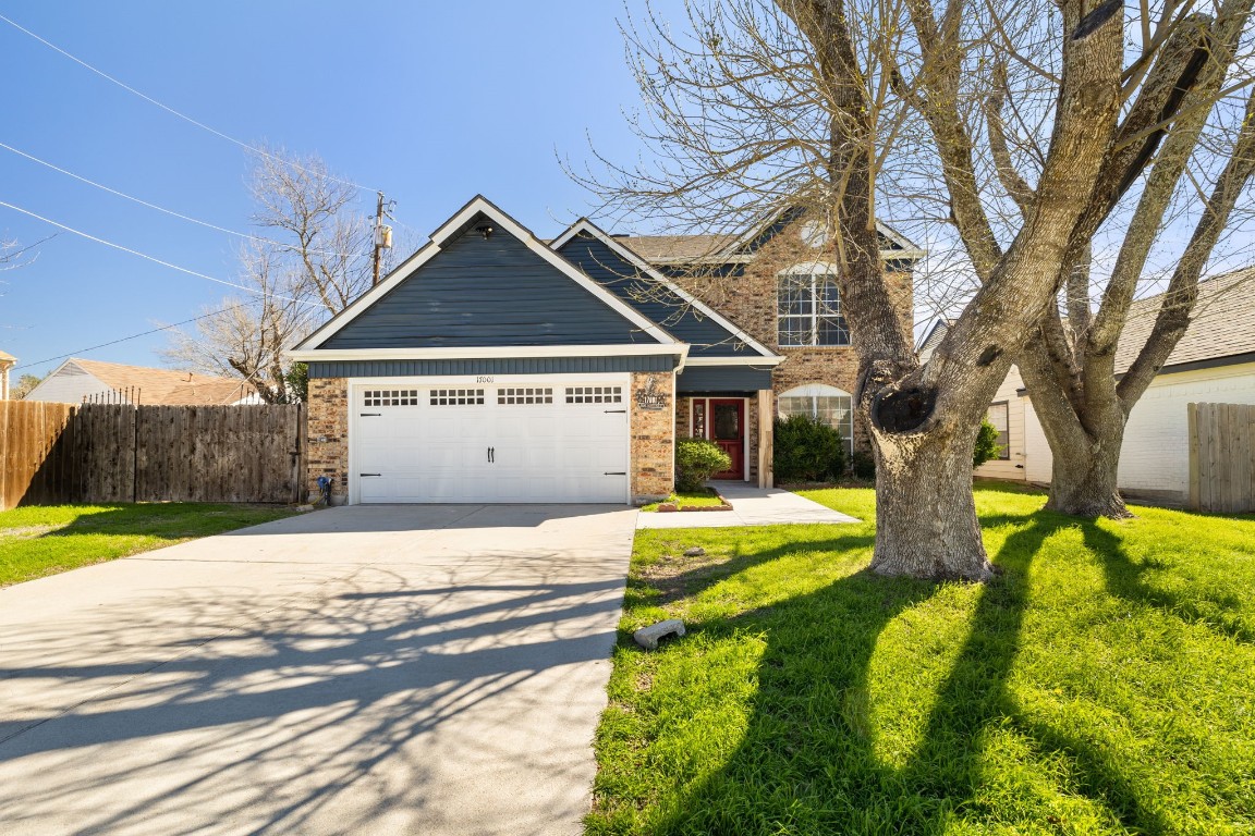 a front view of a house with yard and garage