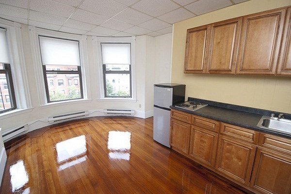 a kitchen with wooden floors and sink