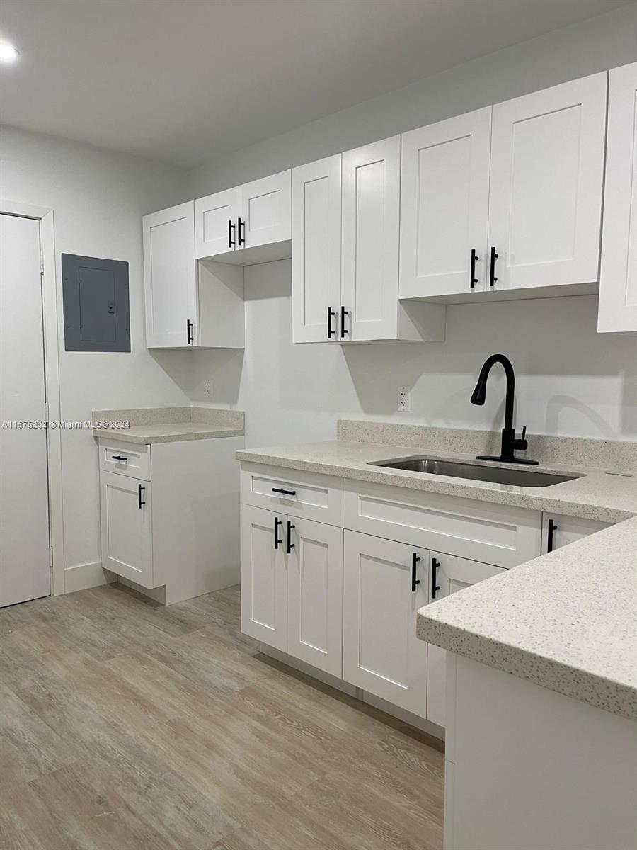 a kitchen with cabinets a sink and appliances