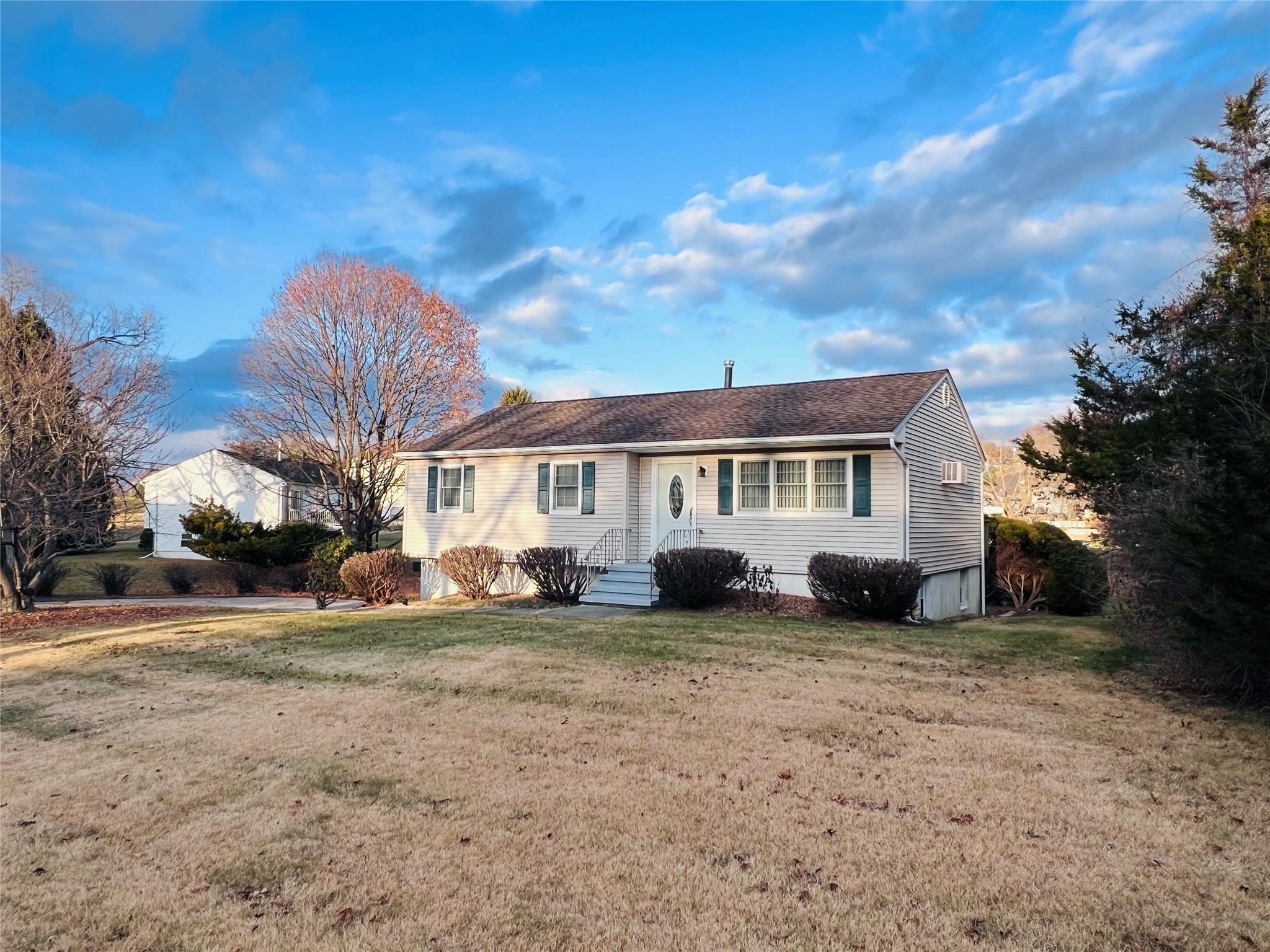 Ranch-style home with a front lawn