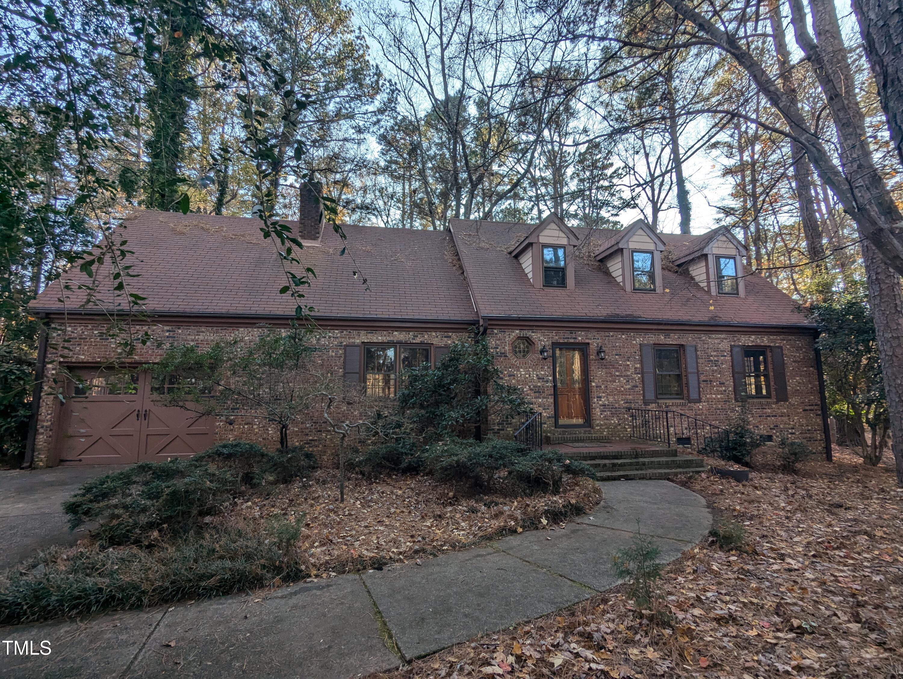 a front view of house with yard and trees