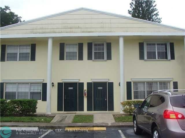 a view of a house with a yard and sitting space