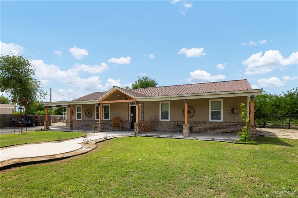 a view of a house with a yard patio and a yard