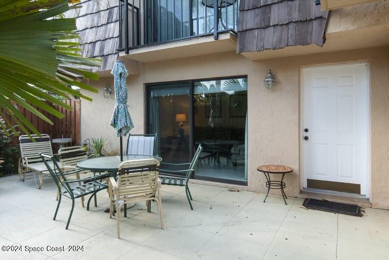 a building outdoor space with patio furniture and potted plants