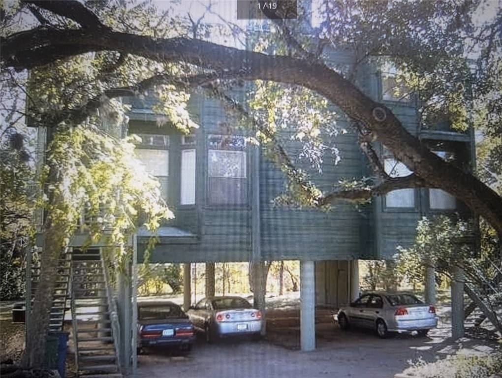 a view of a building from a cars park side of a road