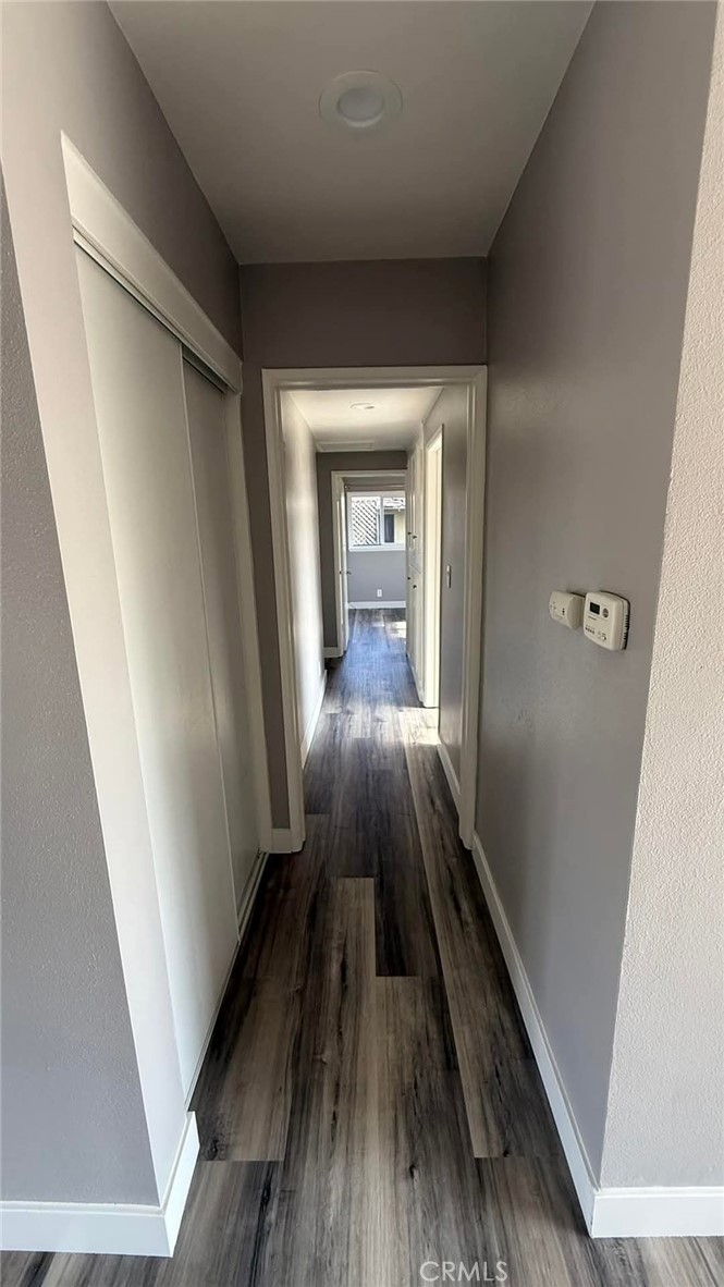 a view of a hallway view with wooden floor and staircase