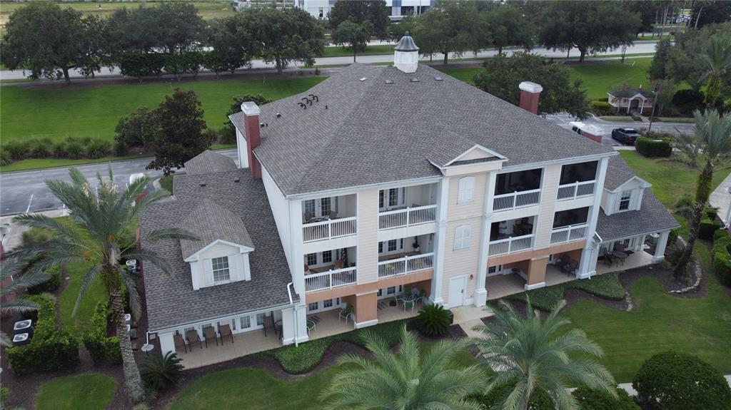 an aerial view of a house with a garden and lake view