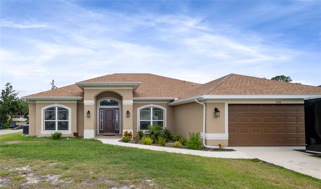 a front view of a house with a yard and garage