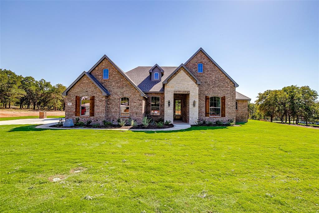 a front view of a house with yard porch and green space