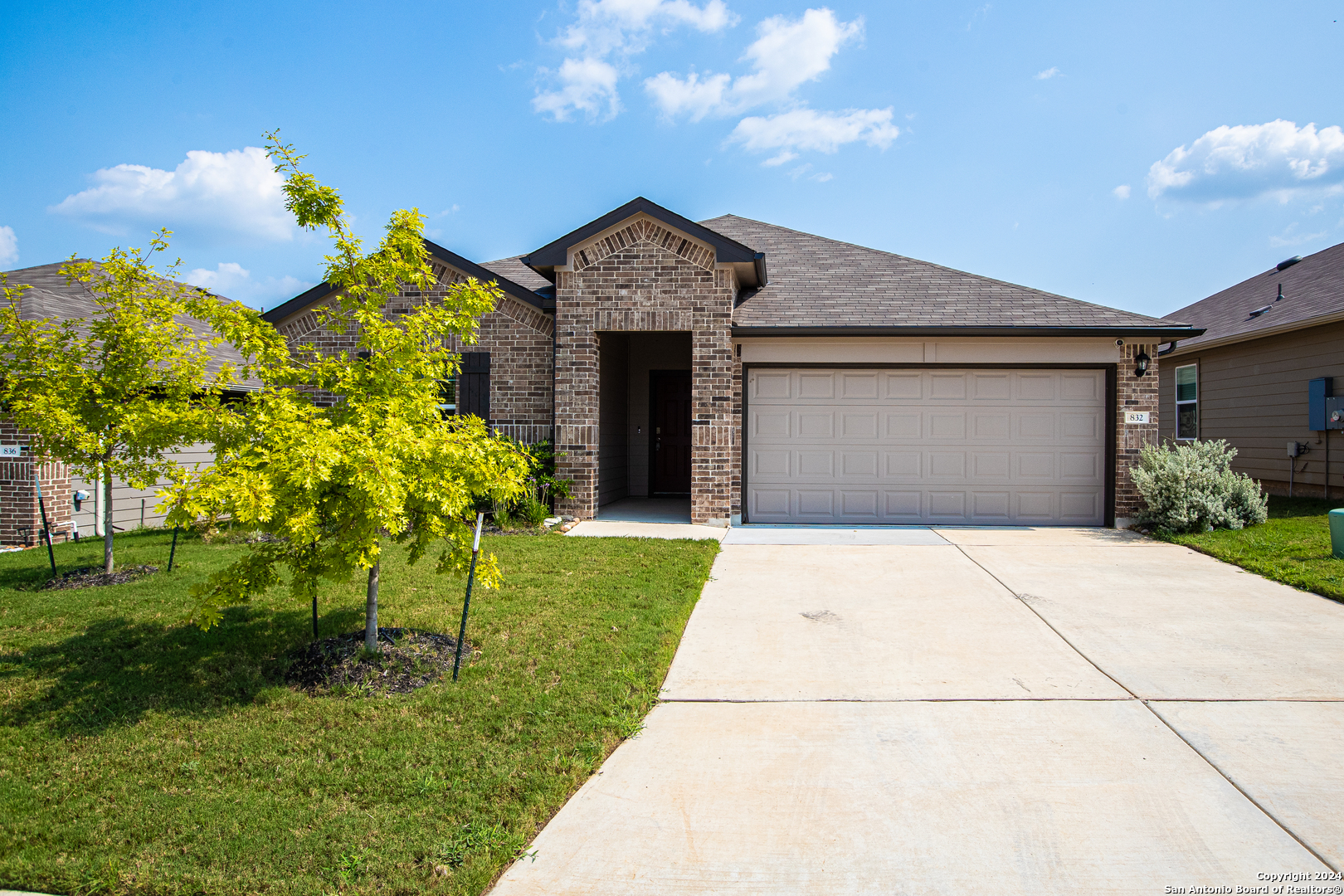 a front view of a house with a yard and garage