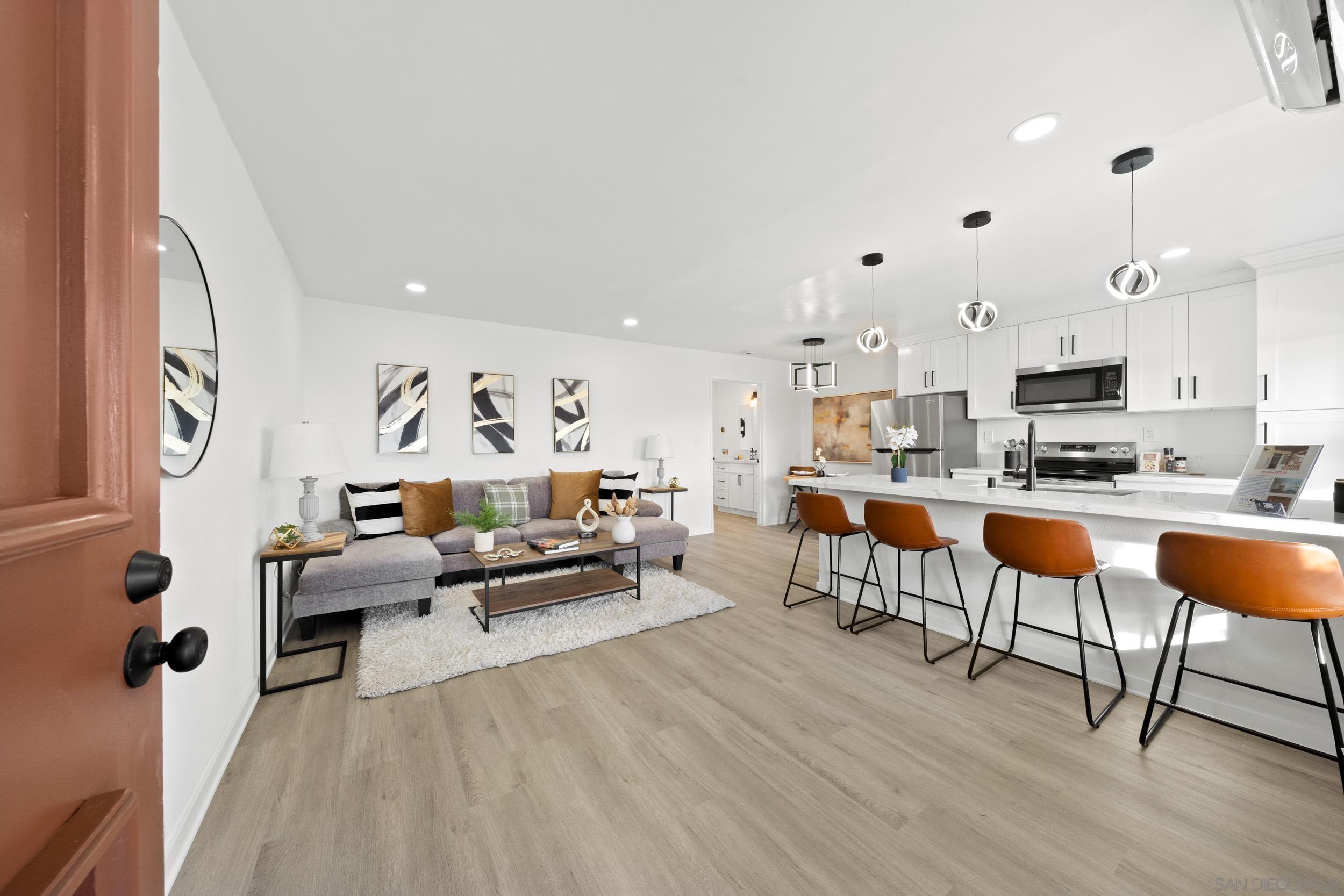 a living room with furniture and a wooden floor