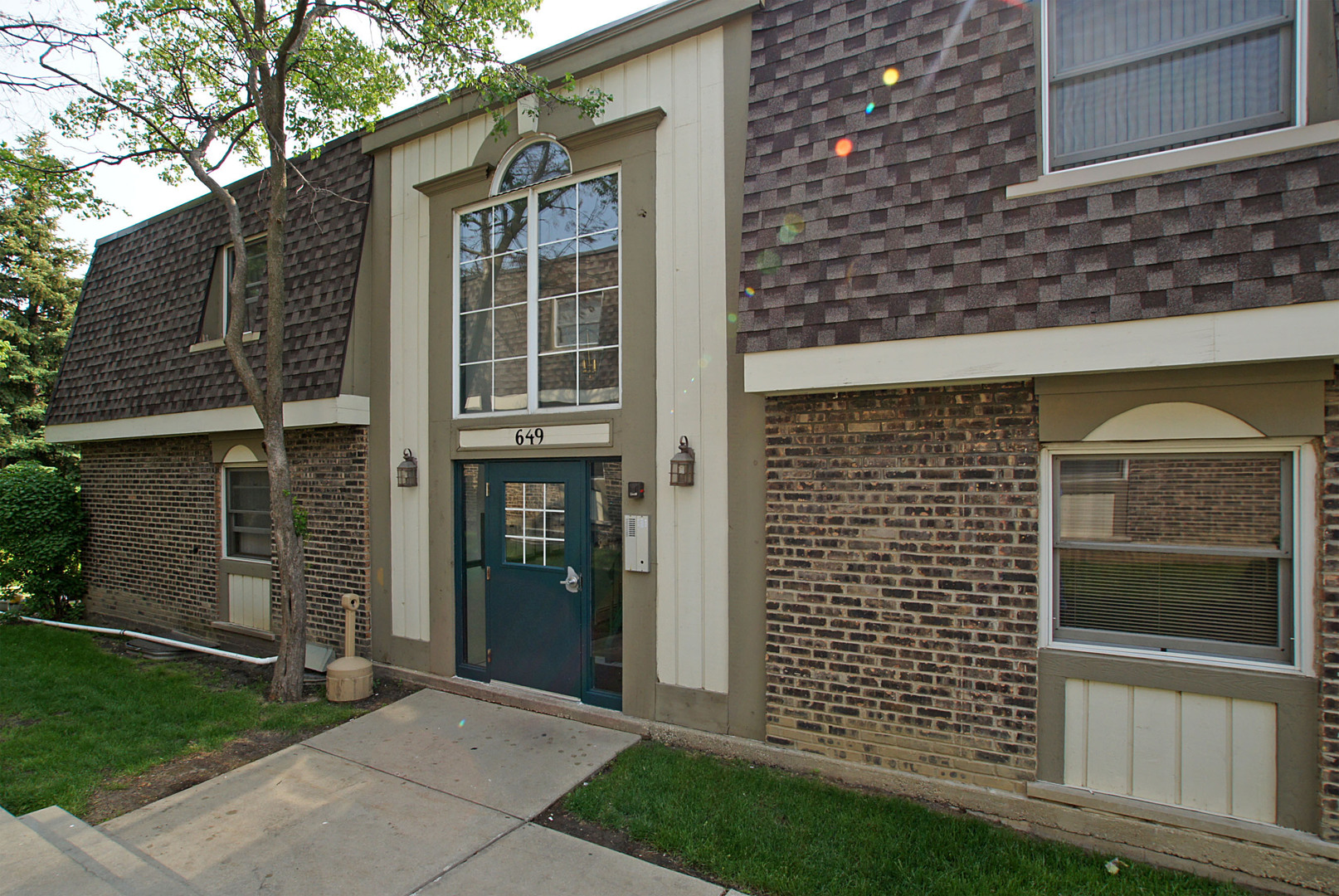 a front view of a house with a garden