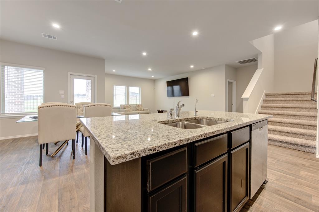 a kitchen with center island table and chairs