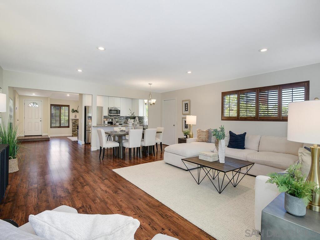 a living room with furniture wooden floor and a table