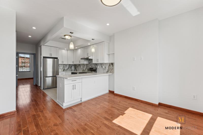 a kitchen with a refrigerator and a sink