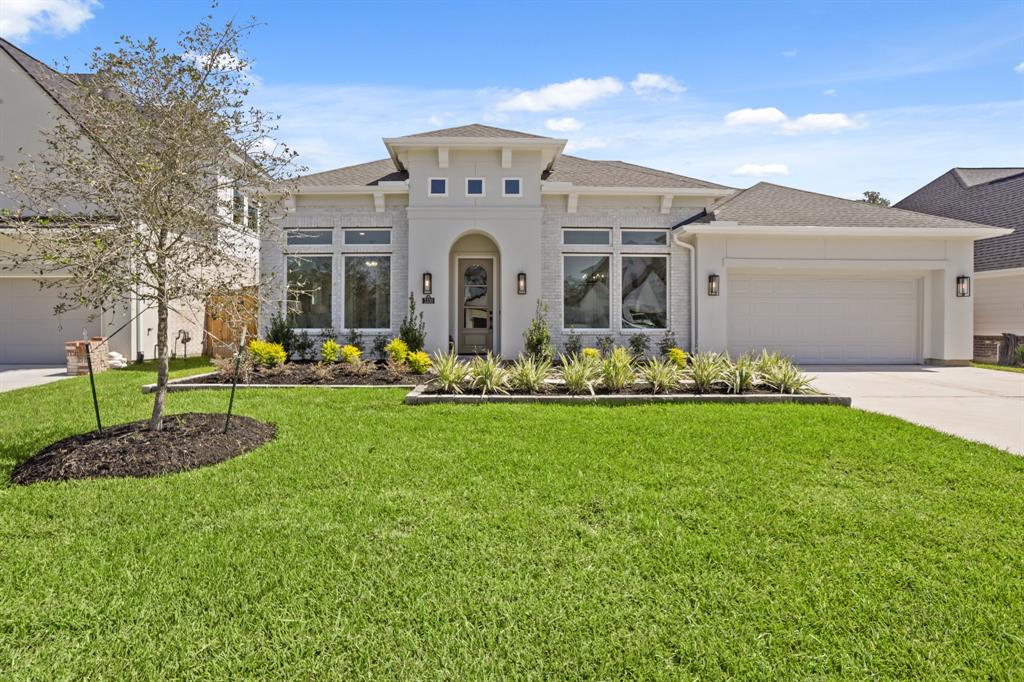 a front view of house with yard and green space