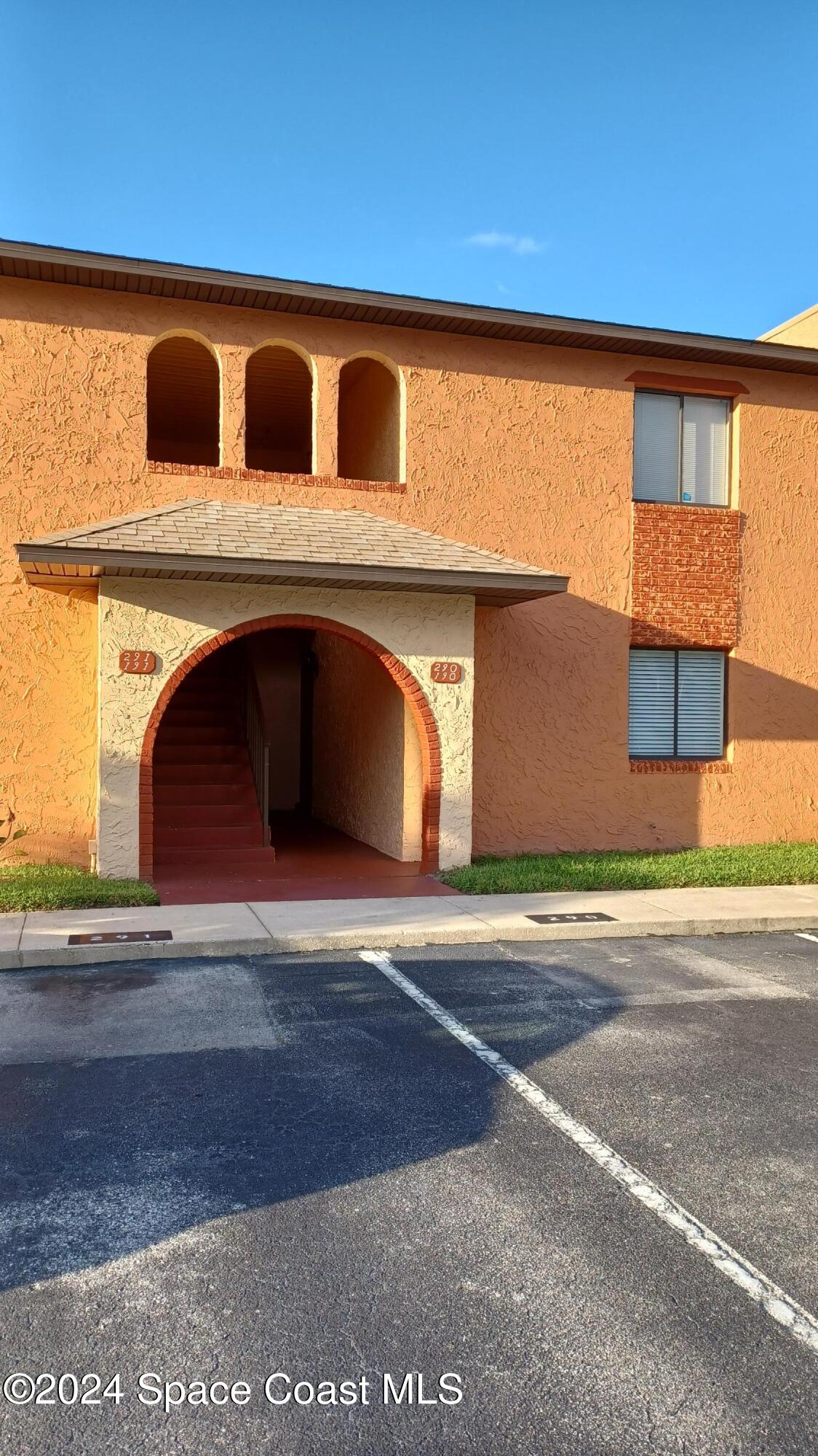 a front view of a house with a garage and a window