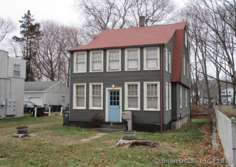 a view of a house with a yard and sitting area