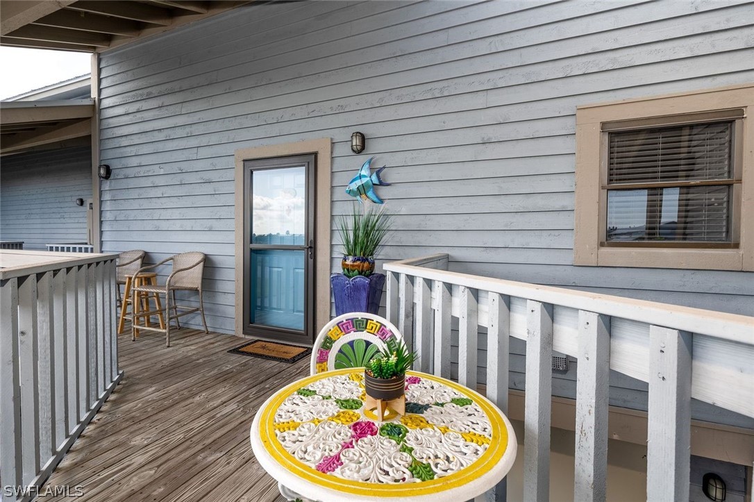 a view of a balcony with table and chairs