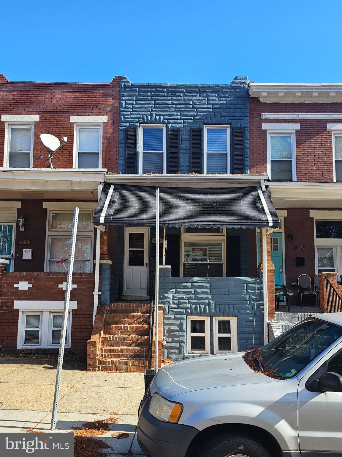 a front view of a house with parking space