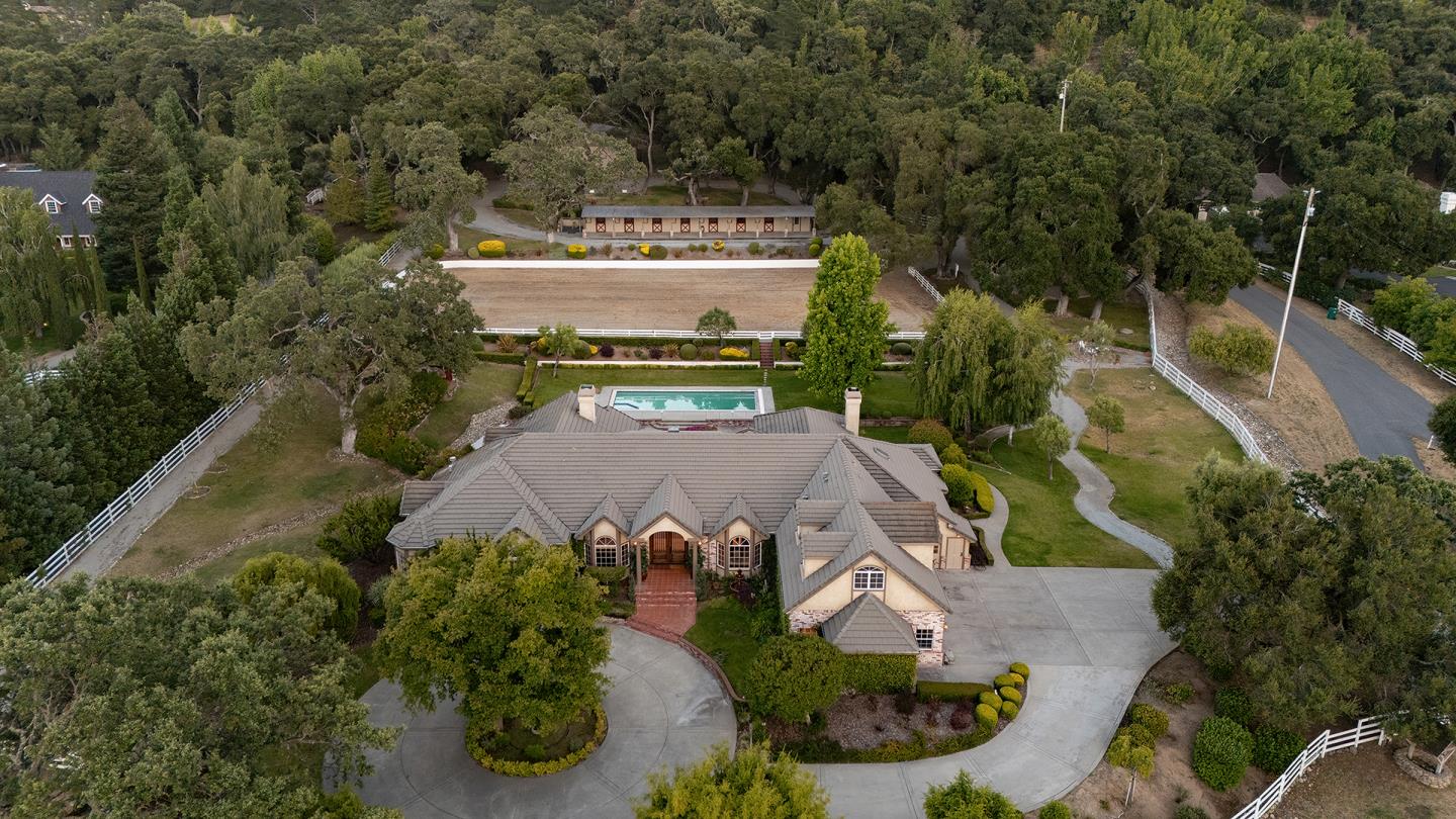 an aerial view of a house with a yard