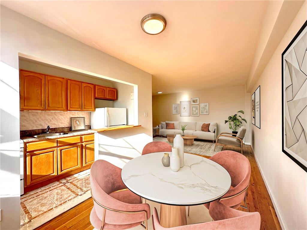 a dining room with furniture a window and kitchen view