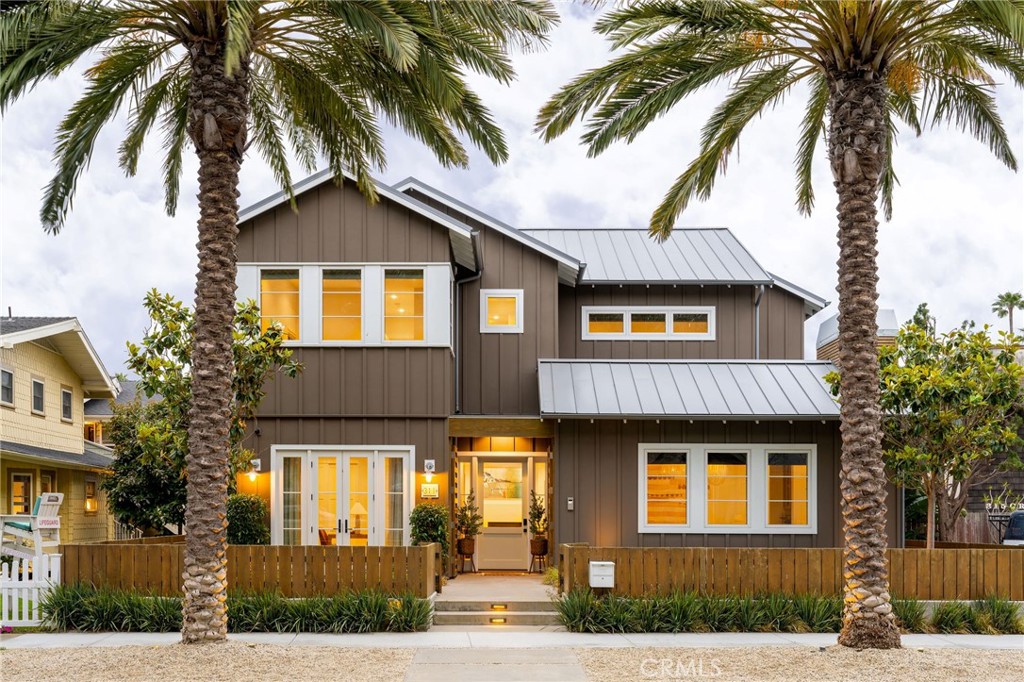 a front view of a house with a tree