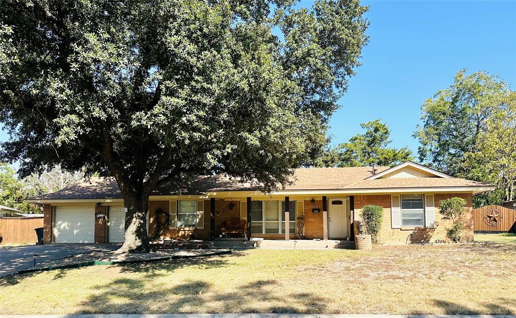 a front view of a house with a yard patio and fire pit