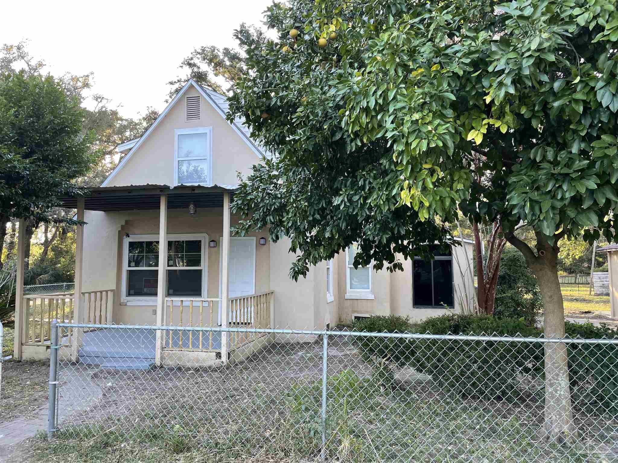 a front view of a house with a garden