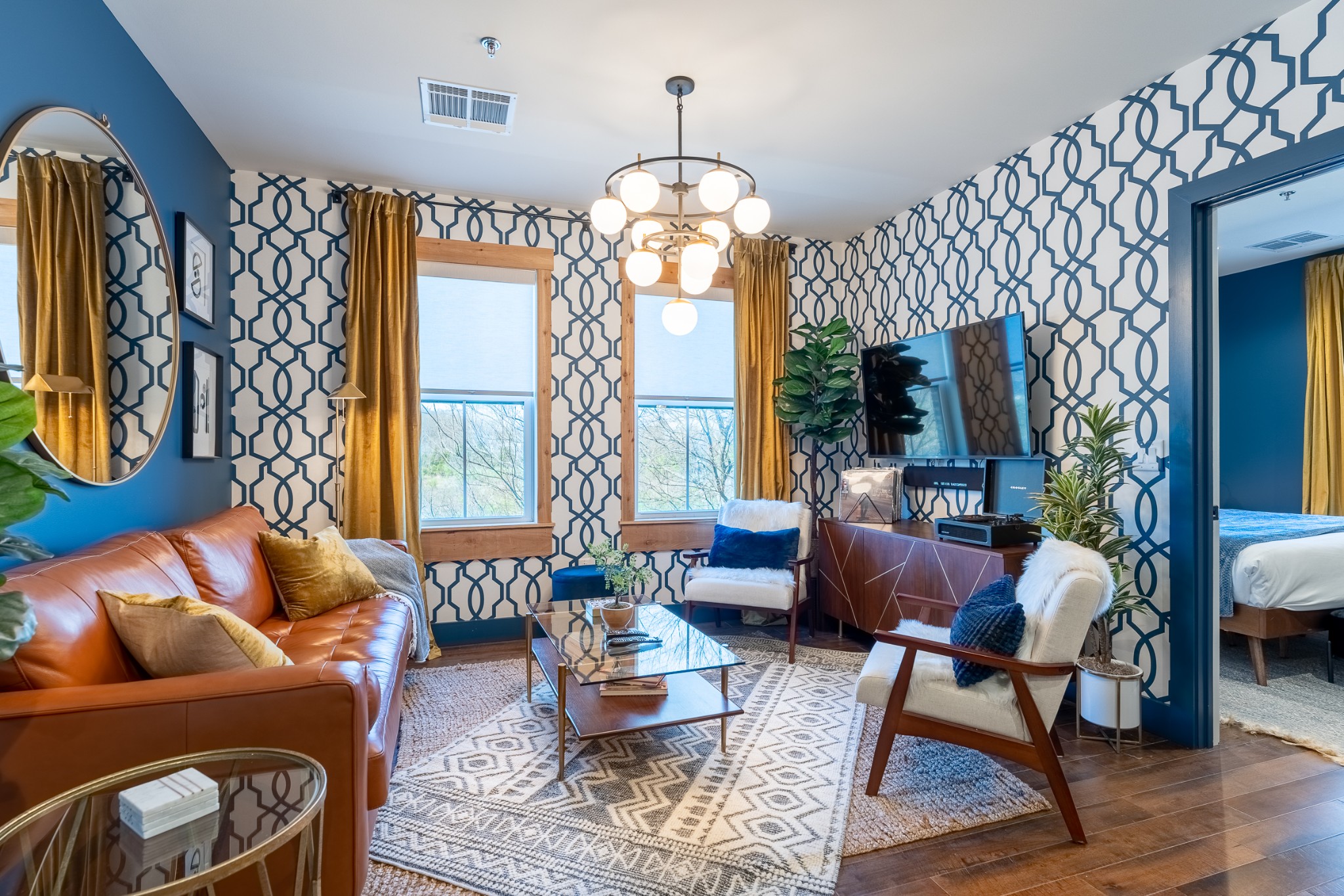 a living room with furniture and a chandelier