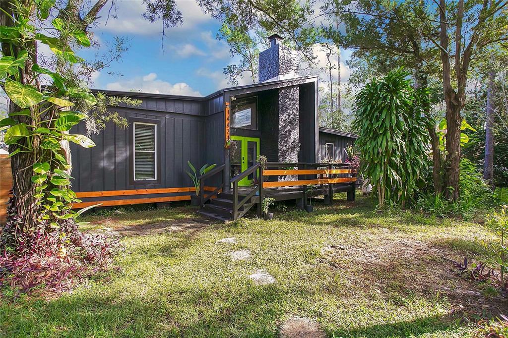 a backyard of a house with yard and outdoor seating