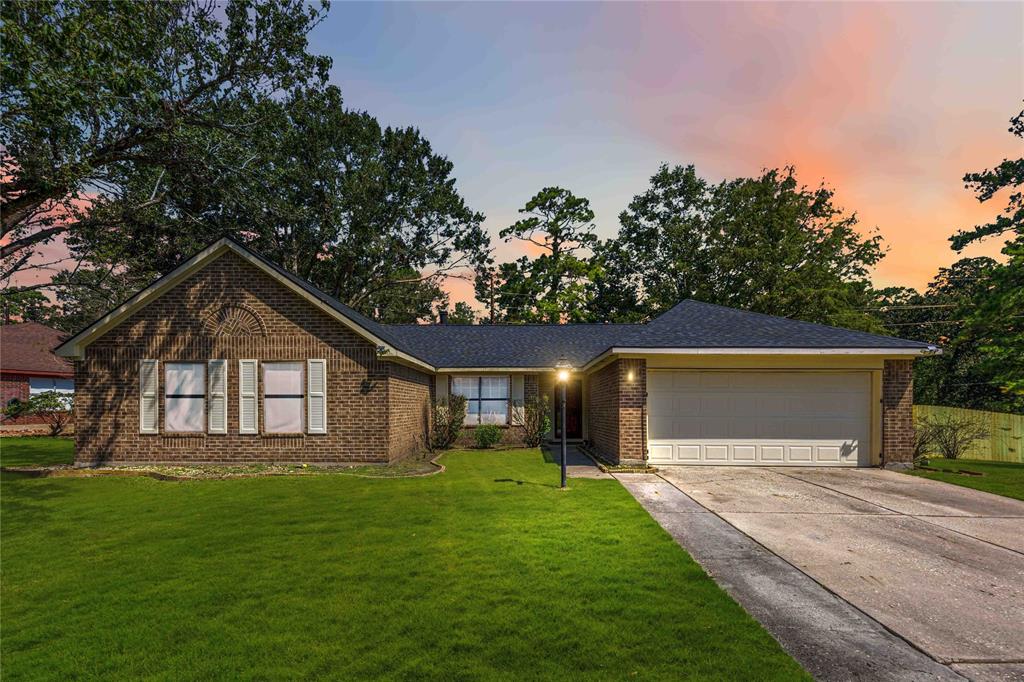 a front view of house with yard and green space