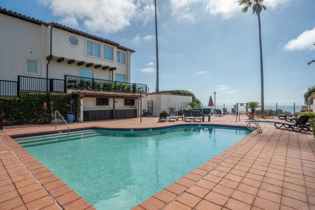 a view of a swimming pool with a lounge chairs