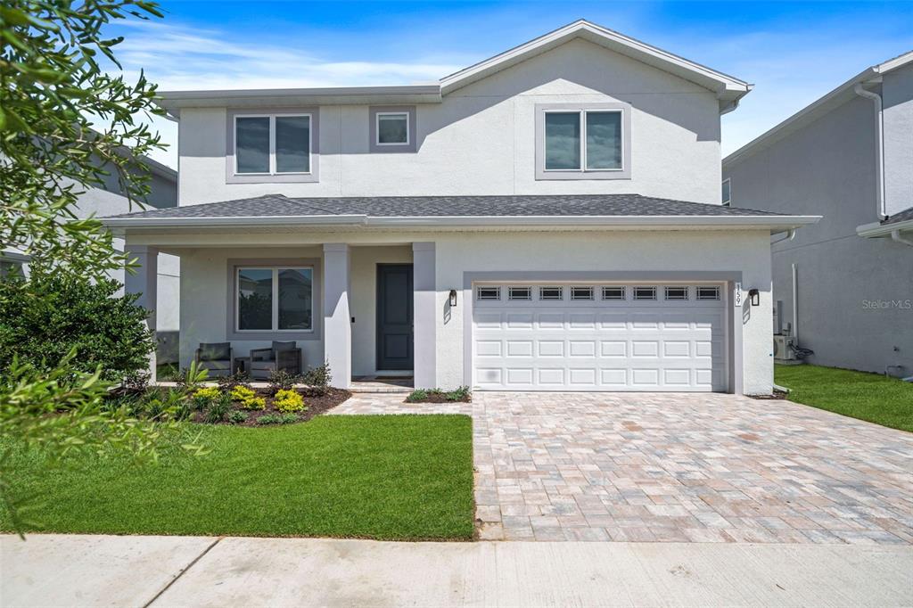 a front view of a house with a yard and garage