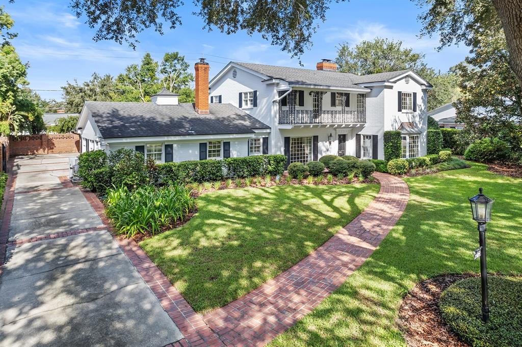 a front view of a house with a garden