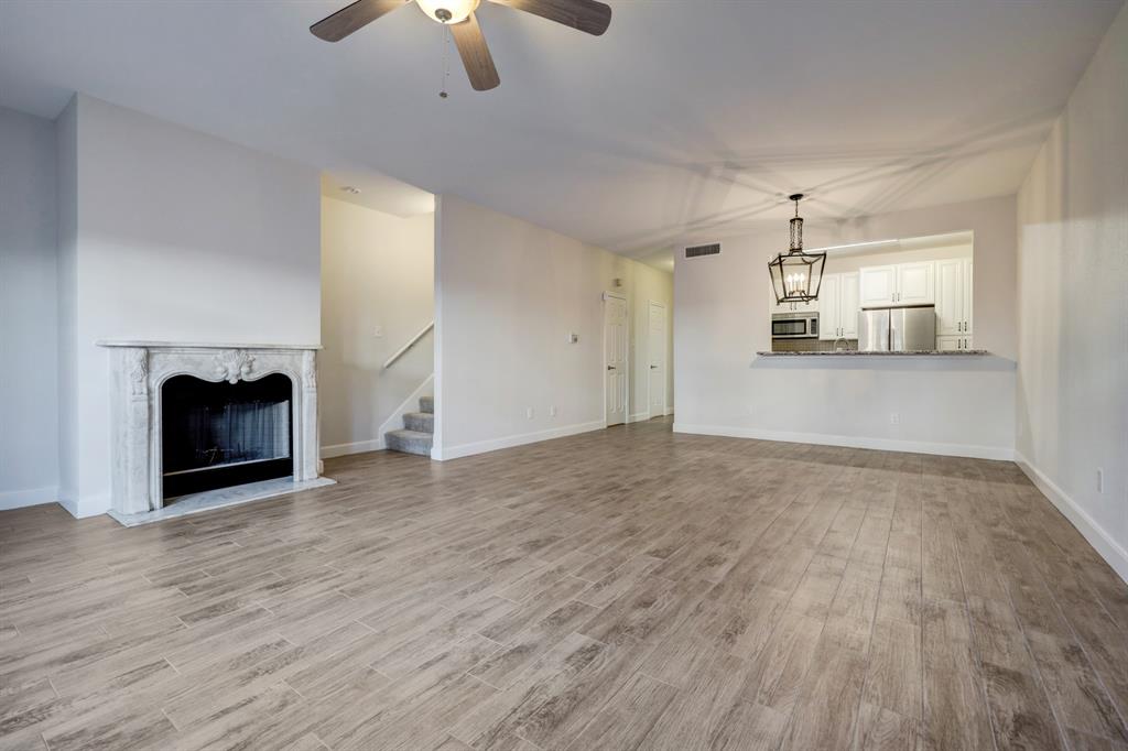 a view of empty room with wooden floor fireplace and outdoor view