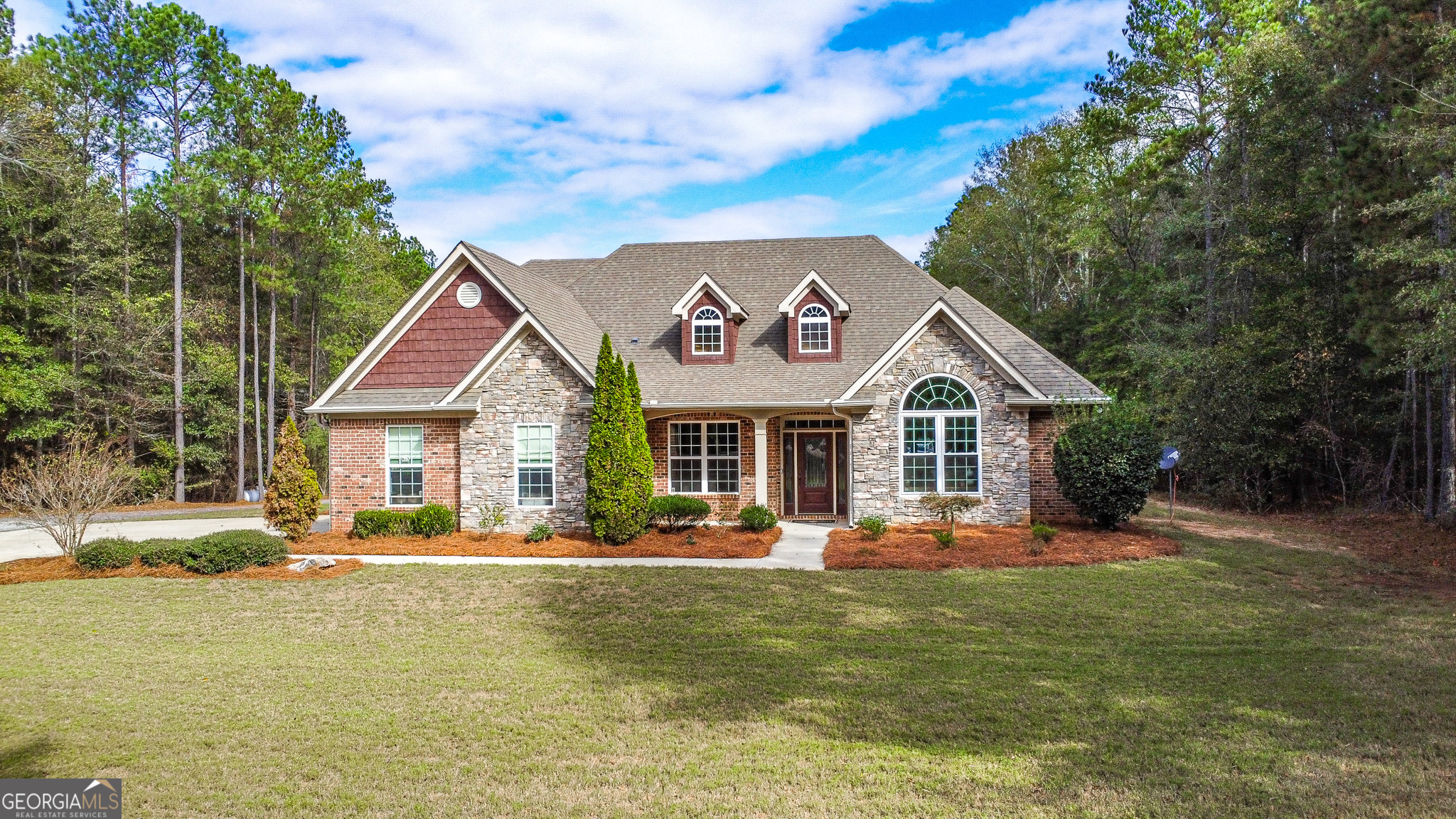 a front view of a house with garden