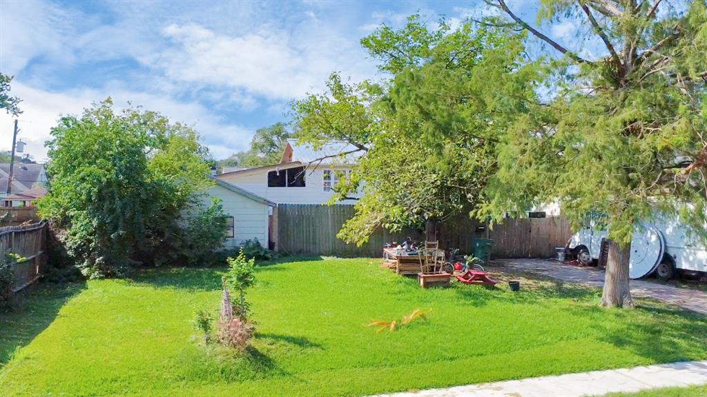 a backyard of a house with table and chairs plants and trees