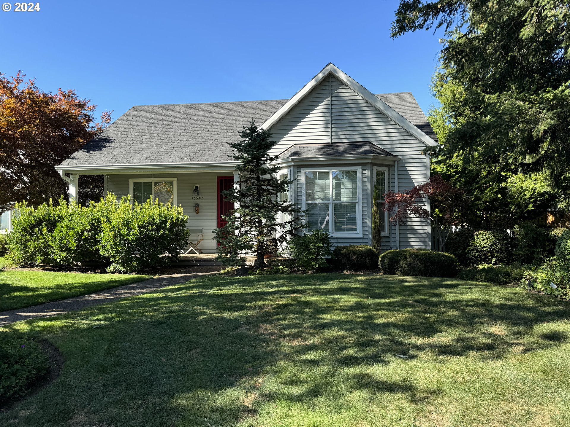 a front view of a house with a garden