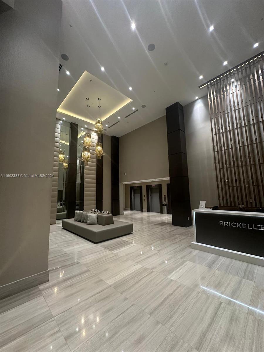 wooden floor with staircase and view of kitchen