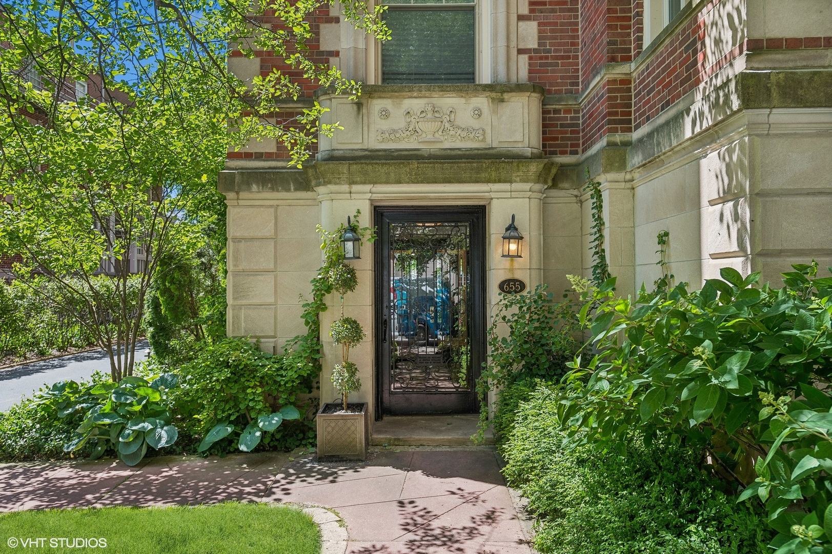 front view of a brick house with a small yard