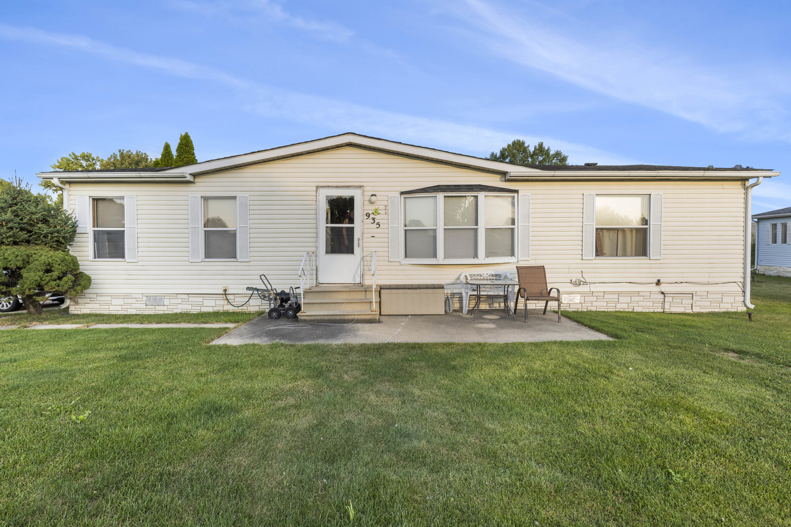 a front view of house with yard and outdoor seating