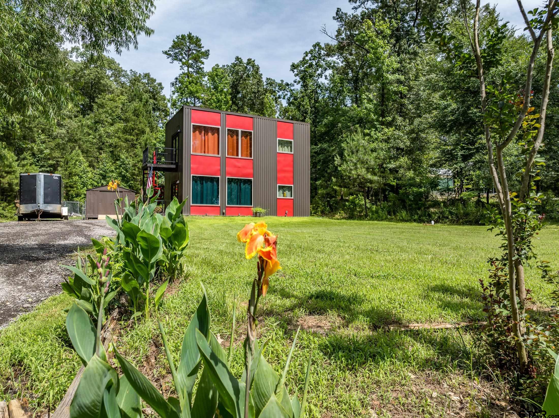 a view of a house with a yard and sitting area