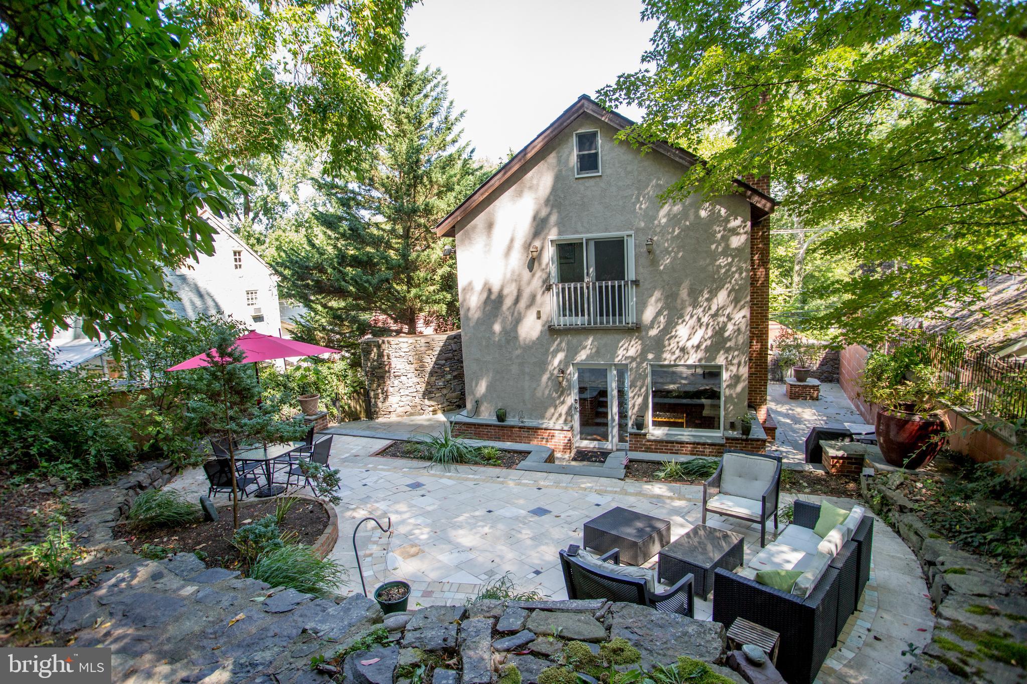 a view of backyard of house with outdoor seating