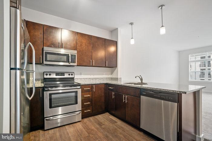 a kitchen with stainless steel appliances granite countertop a sink and stove top oven