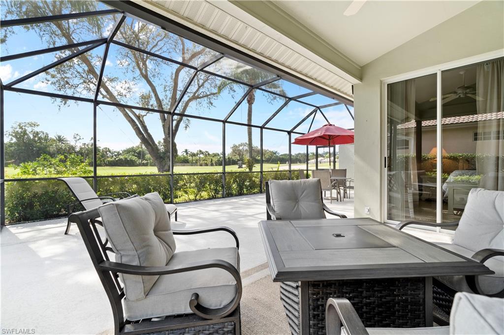 a view of a patio with a table chairs and a backyard