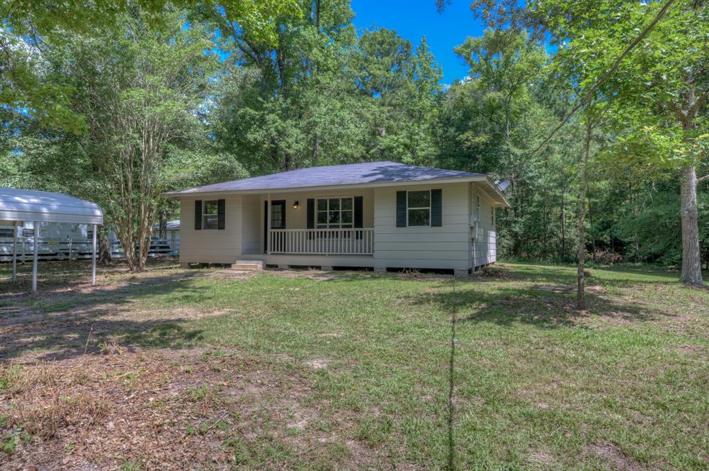 a view of a house with a backyard