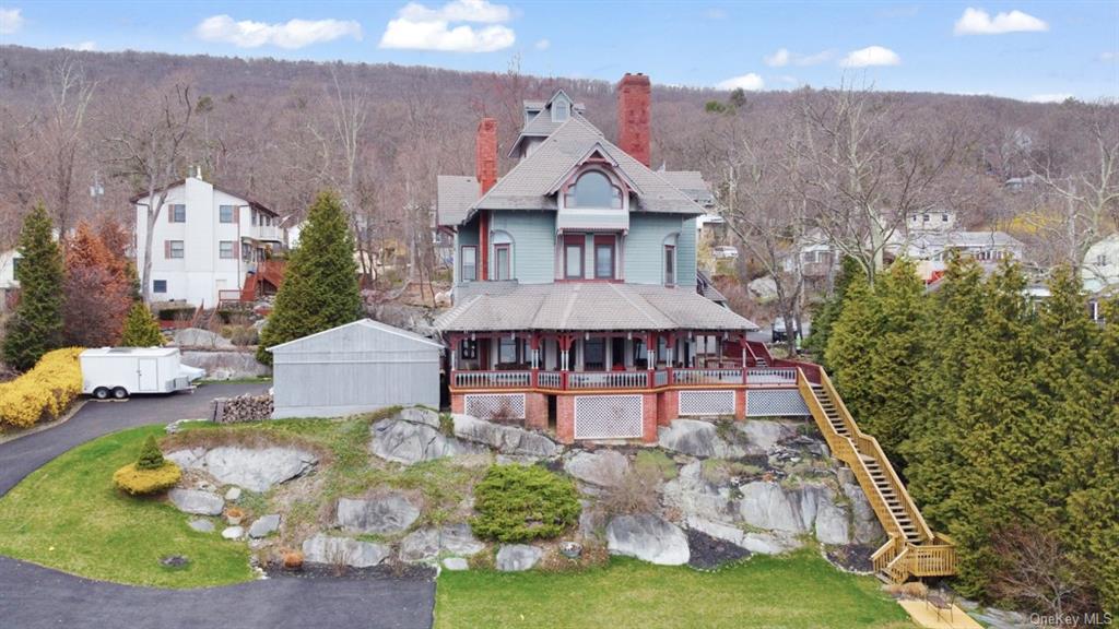 a aerial view of a house with swimming pool and a yard